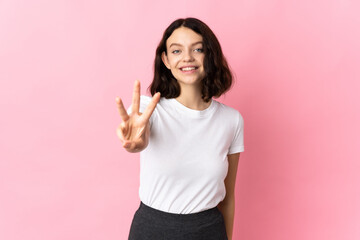 Teenager Ukrainian girl isolated on pink background happy and counting three with fingers