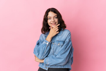 Teenager Ukrainian girl isolated on pink background happy and smiling