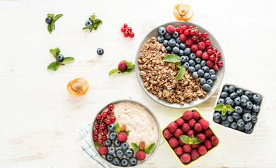 An energetic, delicious breakfast in the morning with granola, oatmeal with fruits and berries. Flat layouts for healthy food