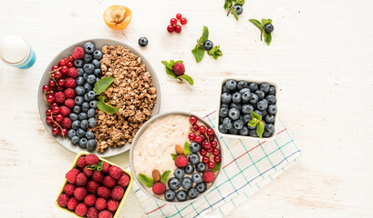 Delicious muesli and oatmeal with fresh seasonal berries, top view for morning healthy breakfast