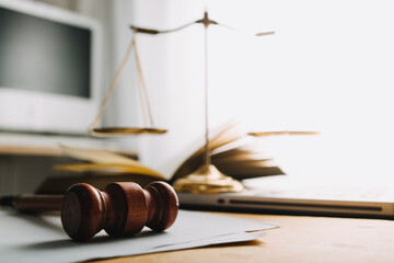 Justice and law concept.Male judge in a courtroom with the gavel, working with, computer and...