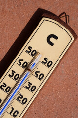 wooden weather thermometer in a really hot day
