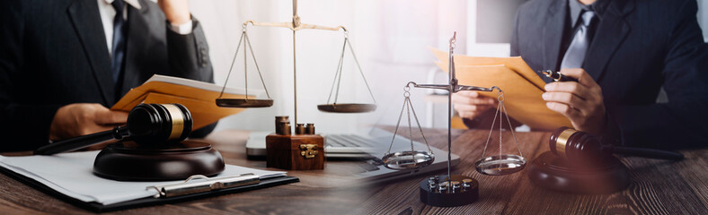 Business and lawyers discussing contract papers with brass scale on desk in office. Law, legal...