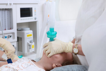 Intubation of the trachea. The child is connected to ventilator. Preparing for surgery. General anesthesia for the child.