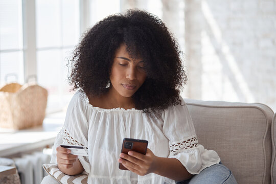 Young Black Woman Spending Money In Internet Websites And Stores And Making Online Payments. Female African Blogger Buying Clothes And Beauty Products. Purchasing Concept.