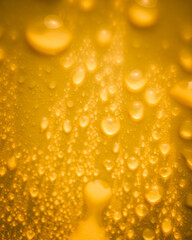 Water droplets on yellow
