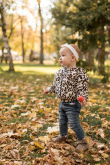 Happy little girl in the autumn park, laughs. Happy autumn