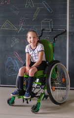 Special child on wheelchair. Girl in school uniform on the background of the school board.