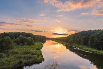 Fototapeta na wymiar The view of the Viliya river in the forest. The sunset over the river. Nature landscape in Belarus