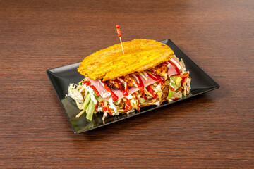 Patacon stuffed with everything, ham, lettuce, stewed pulled chicken meat, fresh cheese, plantain...