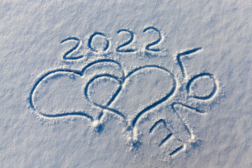 the words love 2022 drawn on the snow
