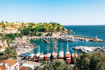 Antalya, Turkey - July, 2021: Top aerial view of marina ancient port in old town Kaleici district in resort city Antalya, Turkey. Old harbour in Antalya.