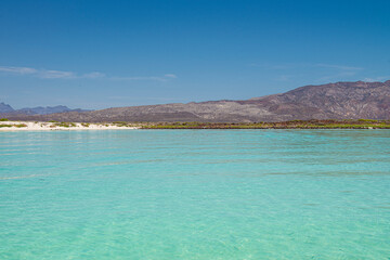 Seascape of baja California Sur. Loreto Mexico with mountains blue sea and white sand beach