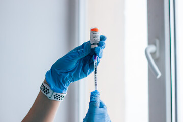cosmetologist doctor recruits into the syringe a drug for Botox injections with an insulin syringe,...