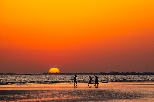 Silhouette of kids playing at beach with sunset background. Yemen nature. Yemen landscape.