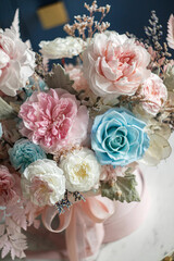Beautiful flowers. Preserved roses with dried flowers bouquet closeup. Beautiful flower arrangement in a pink box.