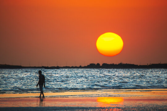 Silhouette of kids playing at beach with sunset background. Yemen nature. Yemen landscape.