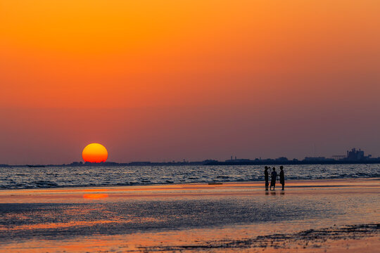 Silhouette of kids playing at beach with sunset background. Yemen nature. Yemen landscape.