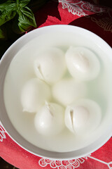 Cheese collection, white balls of Italian soft cheese mozzarella di bufala campana floating is water