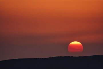 sunset and orange sunrise over the mountains
