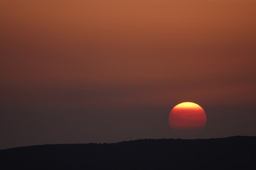 sunset and orange sunrise over the mountains