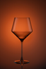 Closeup of a glass against orange background