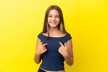 Little caucasian girl isolated on yellow background with surprise facial expression