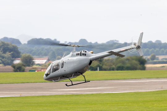 Small executive helicopter making a spirited take off.
