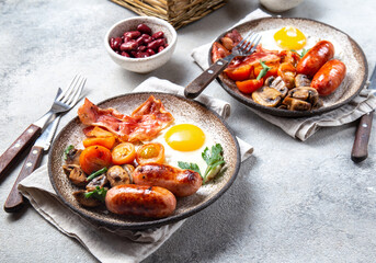 Fototapeta na wymiar English breakfast with fried eggs, bacon, sausages, beans, toasts on white background