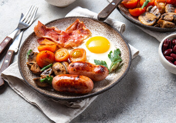 English breakfast with fried eggs, bacon, sausages, beans, toasts on white background