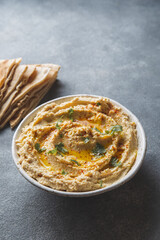 Healthy Homemade Creamy Hummus with Olive Oil and Pita Chips.
