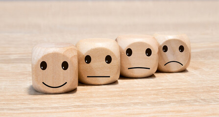 Emoticons with different whims on three wooden cubes
