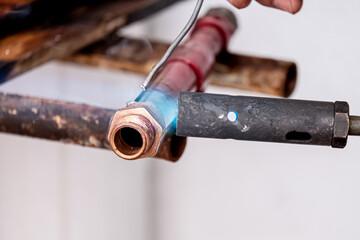 Repair of water pipe of a house. The welding of the pipes that carry the water is shown
