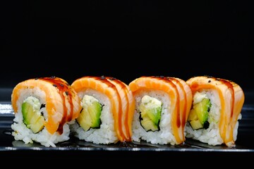 4 pieces of sushi rolls with salmon and avocado