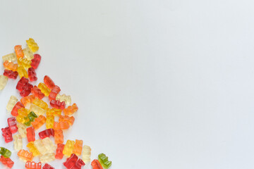 Overhead shot of tasty gummy bears on a white background - space for your content