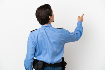 Young police man over isolated background white pointing back with the index finger