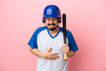Young caucasian man playing baseball isolated on pink background smiling a lot