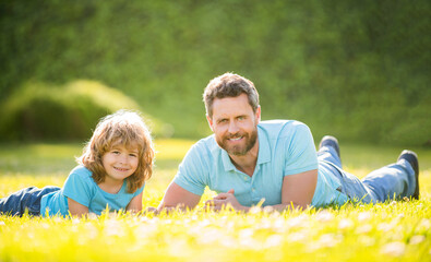 Fototapeta premium fathers day. happy father and son having fun in park. family value. childhood and parenthood.