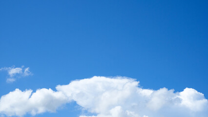 Large white cloud on clear blue sky with copy space