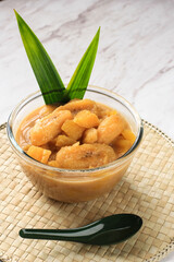 Kolak Pisang Ubi is Banana and Sweet Potato Compote is Popular Indonesian Dessert during Ramadan for Break Fasting. Cooked with Coconut Milk, Palm Sugar,and Pandan Leaf. Copy Space for Text