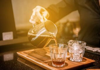 Barita pouring coffee into a cup