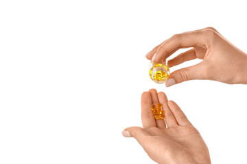 Woman taking pills on white background