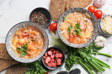 Composition with tasty sauerkraut soup on light background