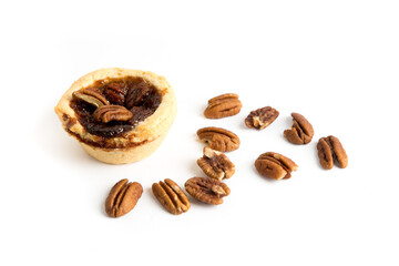 Pecan tart with loose pecans isolated on white
