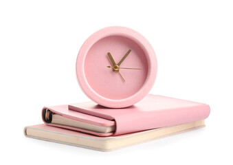 Alarm clock with notebooks on white background