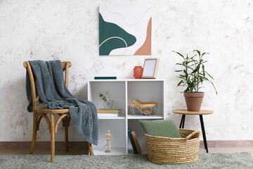 Interior of stylish living room with chest of drawers