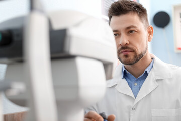Fototapeta premium Male ophthalmologist working in clinic