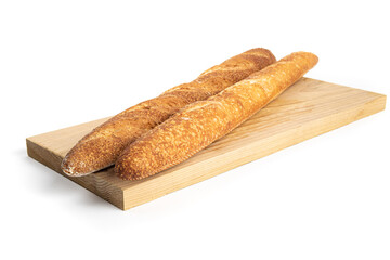 Two crusty bread French sticks or baguettes on a wooden board isolated on white