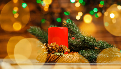 Burning candles over old wooden table with bokeh lights. Christmas candles and lights. Festival...
