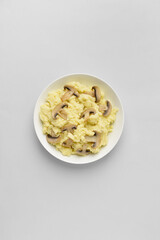 Bowl with tasty mashed potatoes and mushrooms on light background